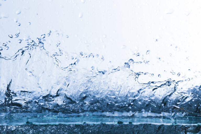 Flowing water, drops, sprays, splashes on a neutral background, studio light, abstraction, minimalism
