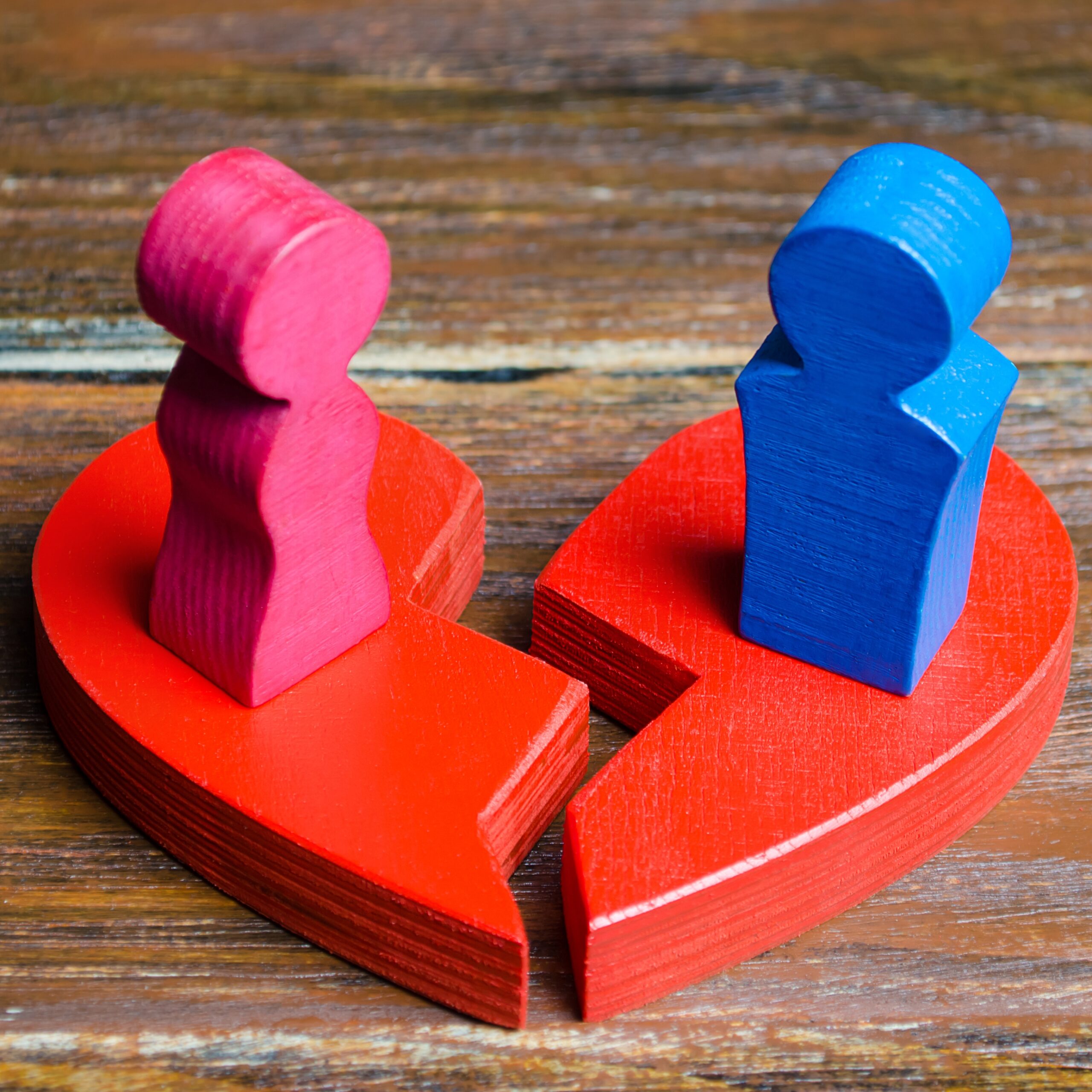 A red broken heart with a couple in lovers. Renewal of the relationship. Family psychotherapist services. Reconciliation. Saving the family. Search for compromises. Dispute resolution