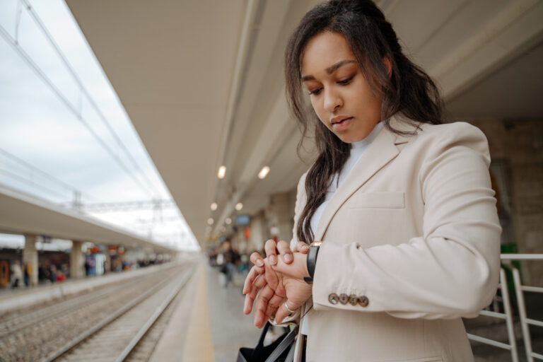 woman-traveler-standing-at-railway-station-looking-2025-02-20-09-53-21-utc